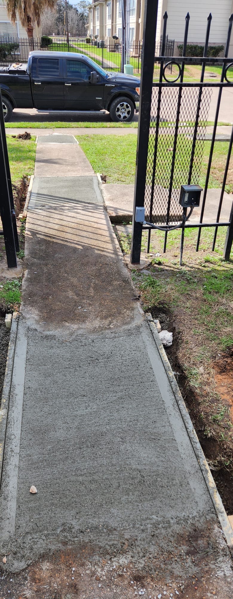 Sidewalk pour at gate • Exterior